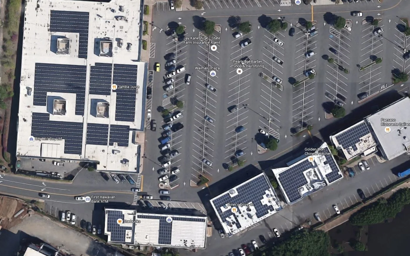 Aerial view of the Waimalu Plaza retail centre with photovoltaic arrays across five building rooftops